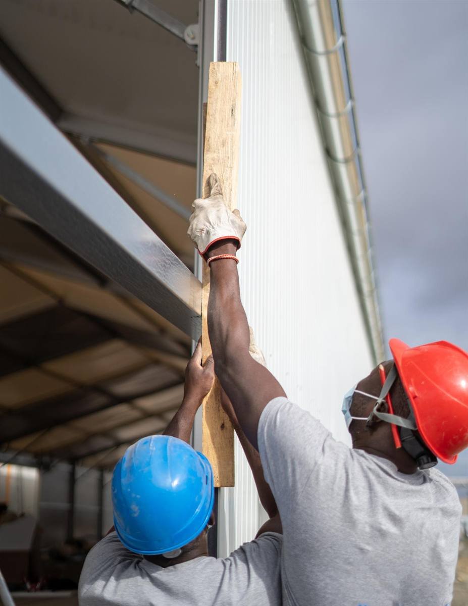 Workers installing building components